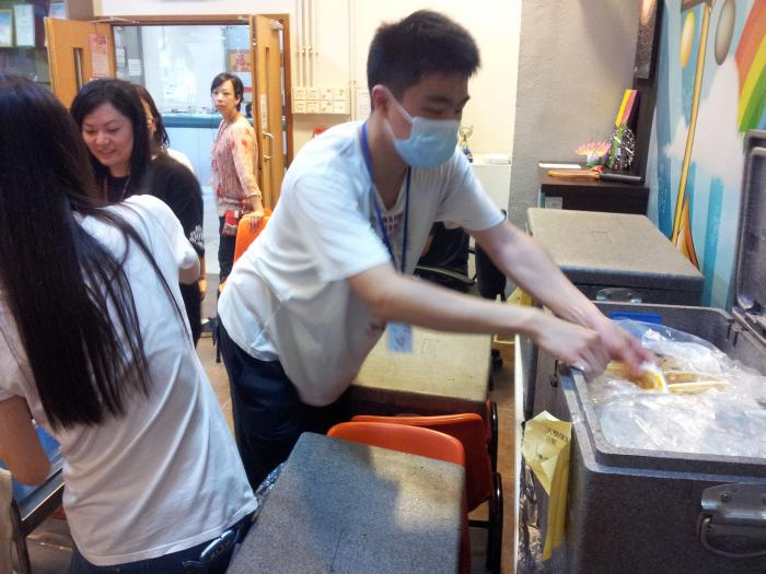 Volunteers distributing dinner to the families
