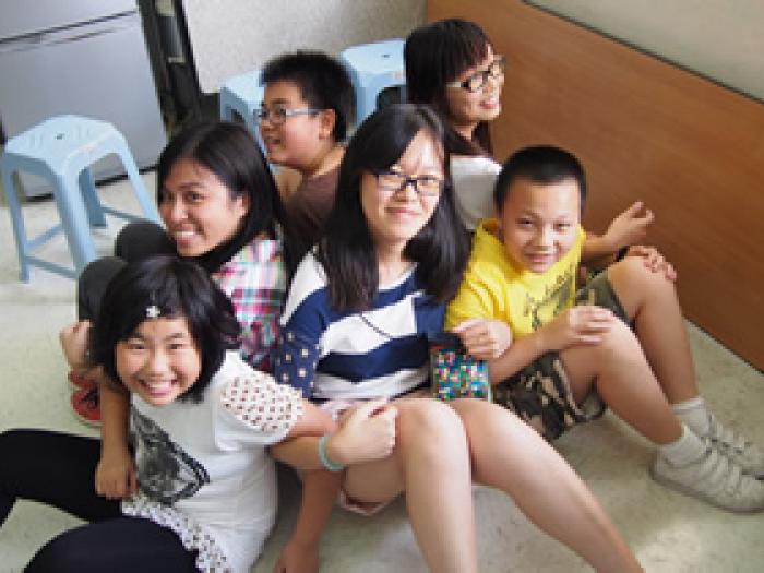 Volunteers and children playing team building game