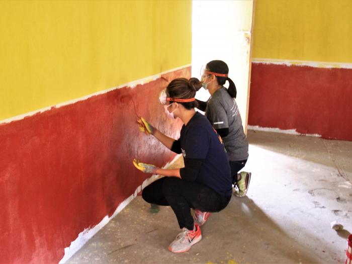 Assisting in renovating school buildings