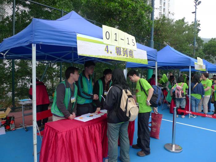 Volunteers assisting participants to sign in at registration counter