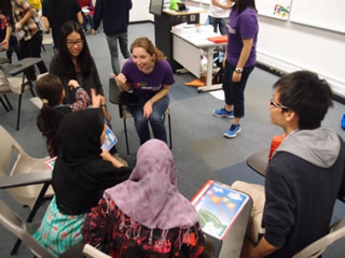 Volunteer chatting with children during the break