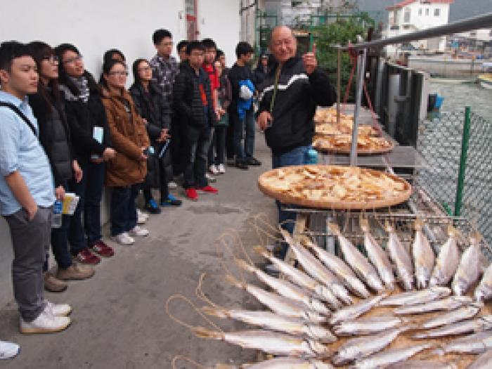 Uncle Wing, a local Tai O resident, telling volunteers about the history of the community