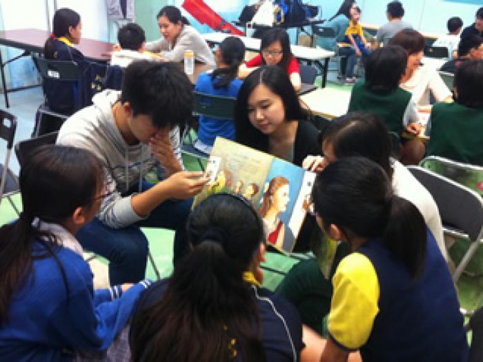 Volunteers reading story to the children
