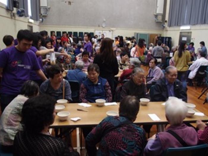 Volunteers distributing Chinese soup to the elders	