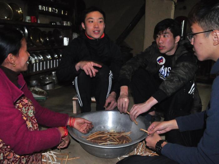 Stringing beans with a local woman. 