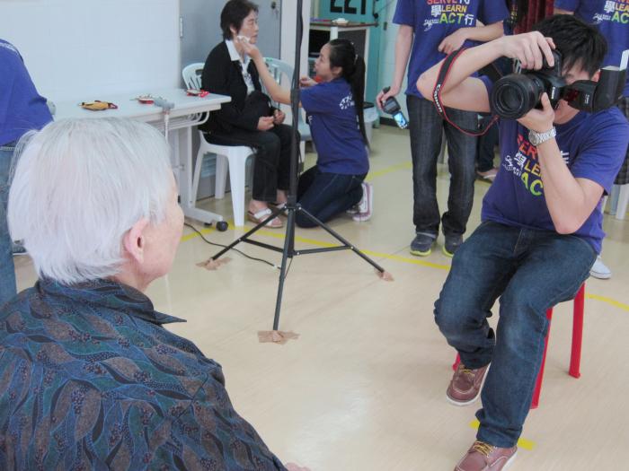 volunteer taking photo of an elder