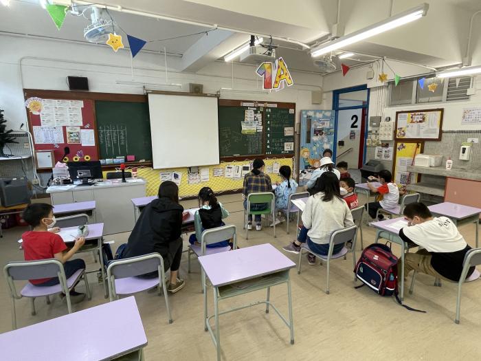 Volunteers helping primary students with their homework