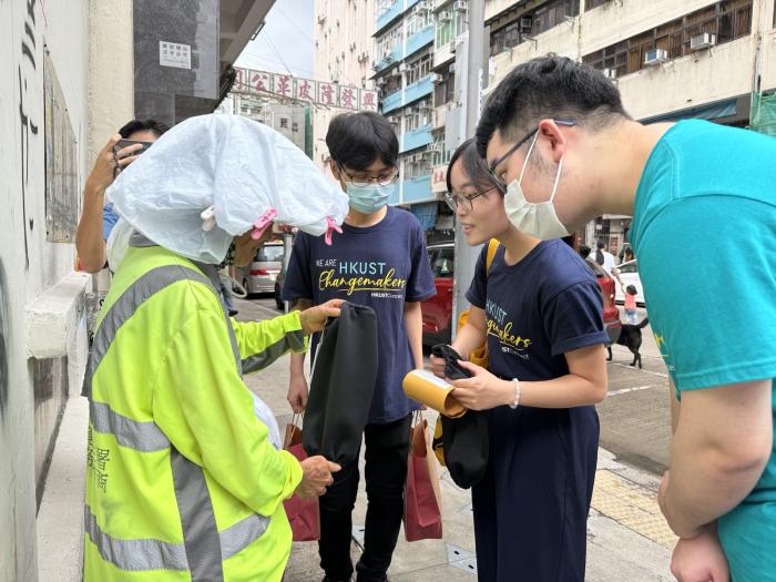 Volunteers distributing Oversleeves to street cleaners