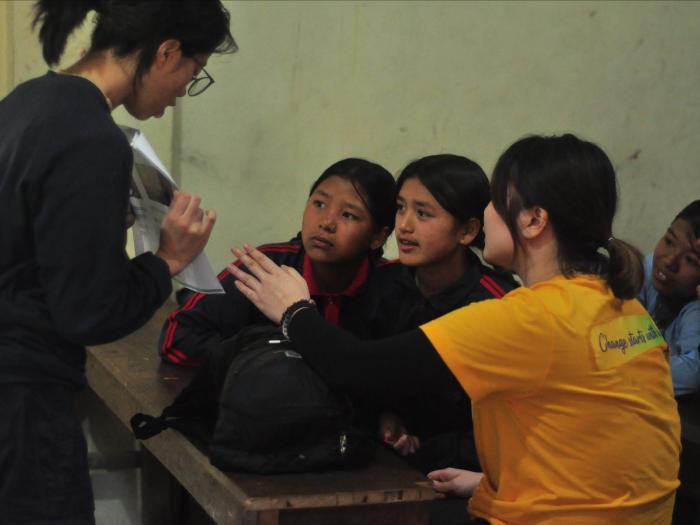 Volunteers teaching students