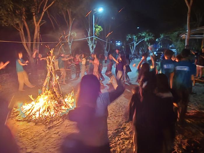 Volunteers and local youth enjoying a campfire night together