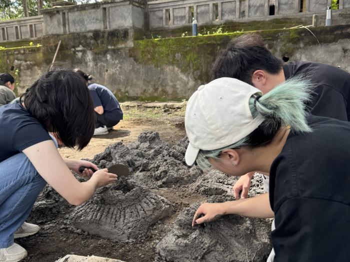Volunteers experiencing the process of making artificial corals