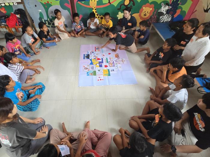Volunteers co-creating artwork with primary school students at Suwandi Foundation