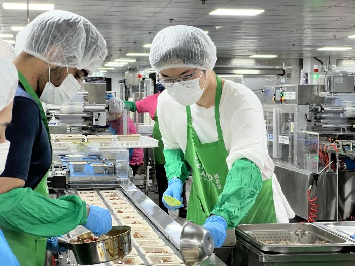 Volunteers working together to prepare meal boxes from high-quality surplus food