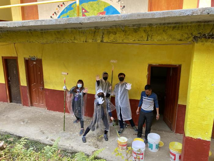 Trip participants getting ready to paint the wall