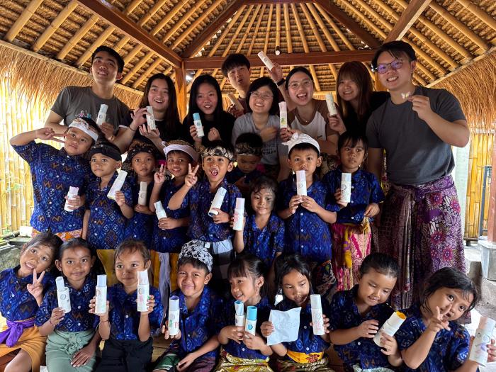 Trip participants taking group pictures with the students