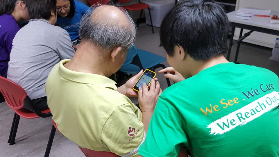 An elder trying to use a smart phone