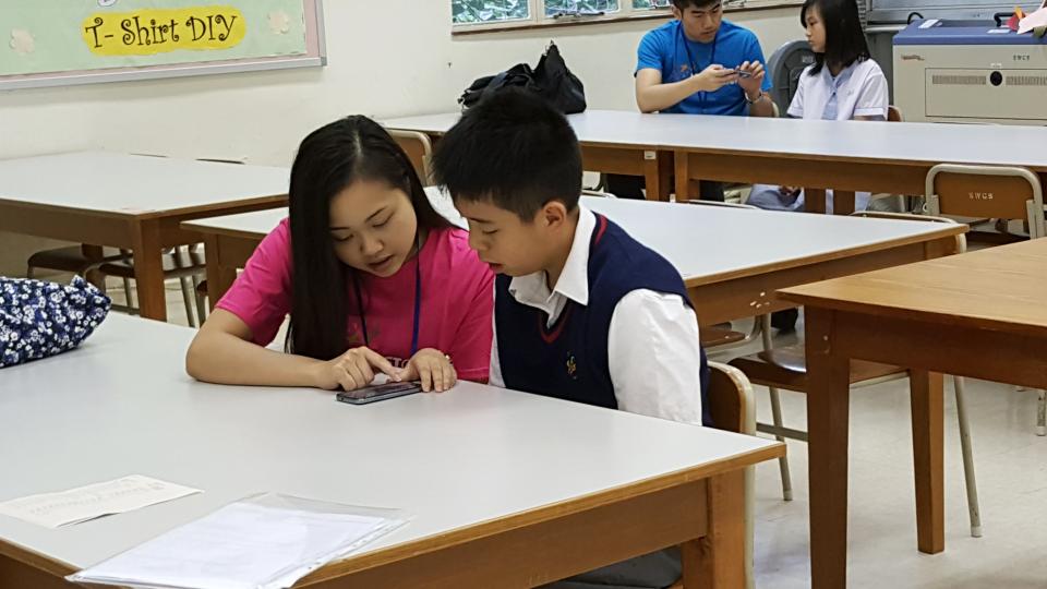 Volunteer collecting voice sample from secondary school student