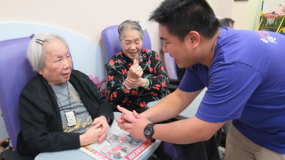 Volunteer chatting with elderly
