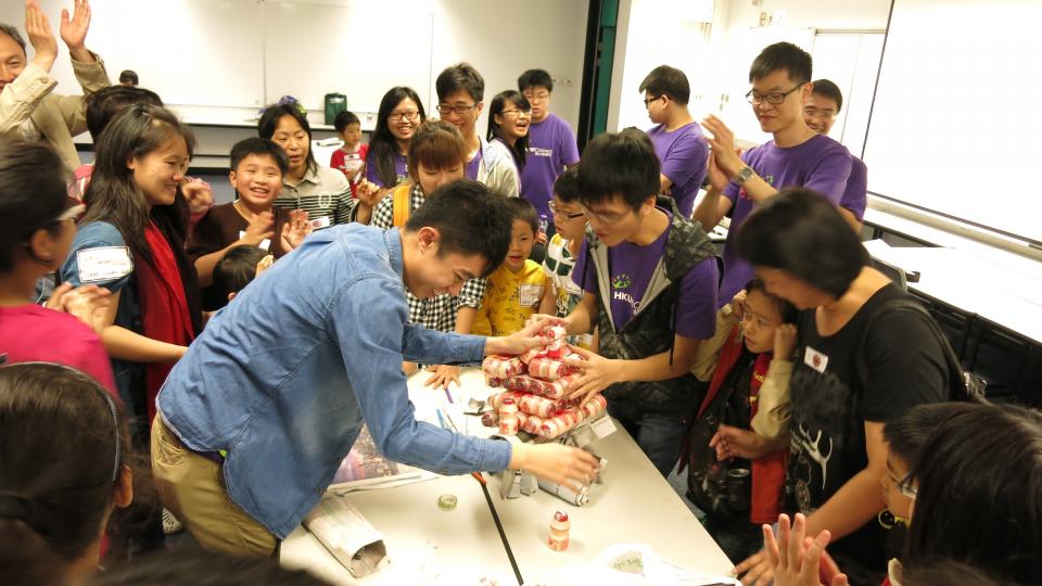 Kids and parents playing a group game together happily