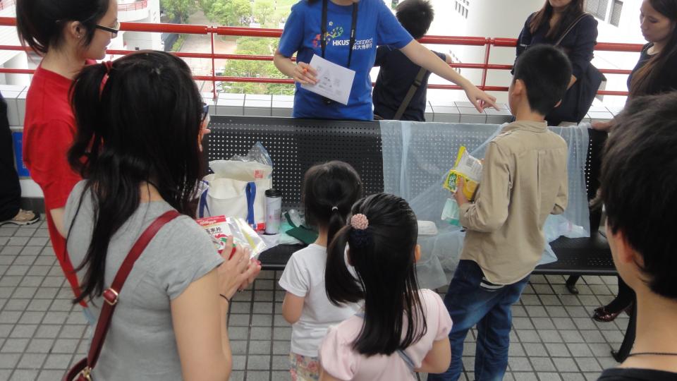 Volunteer distributing different game materials to the children