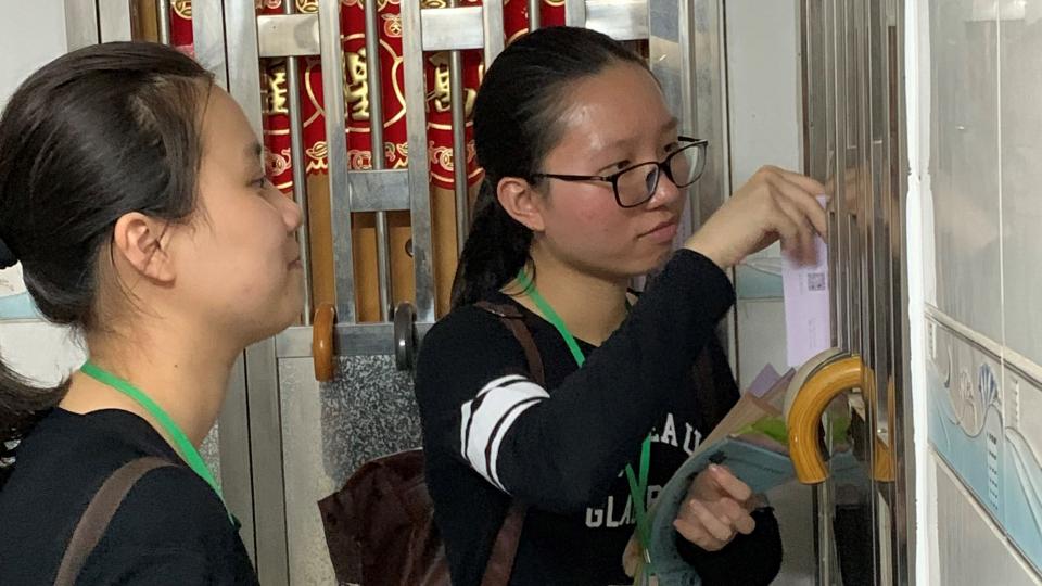 Volunteers approaching a household living in a subdivided housing unit