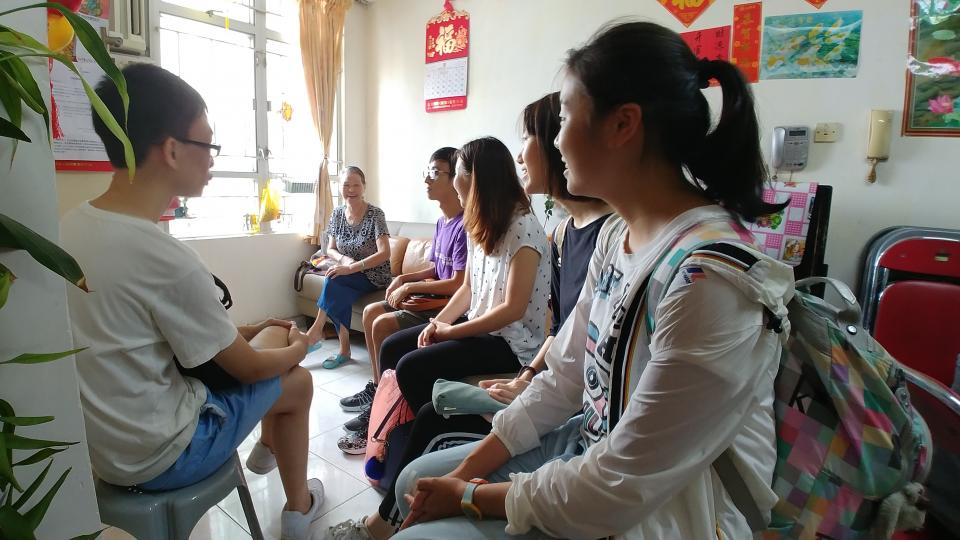 Volunteers talking with the Elderly
