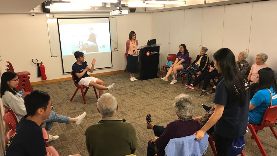 Elderly learning exercise with volunteers