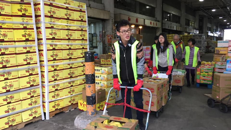 Volunteers saving boxes of bananas from going to the landfill