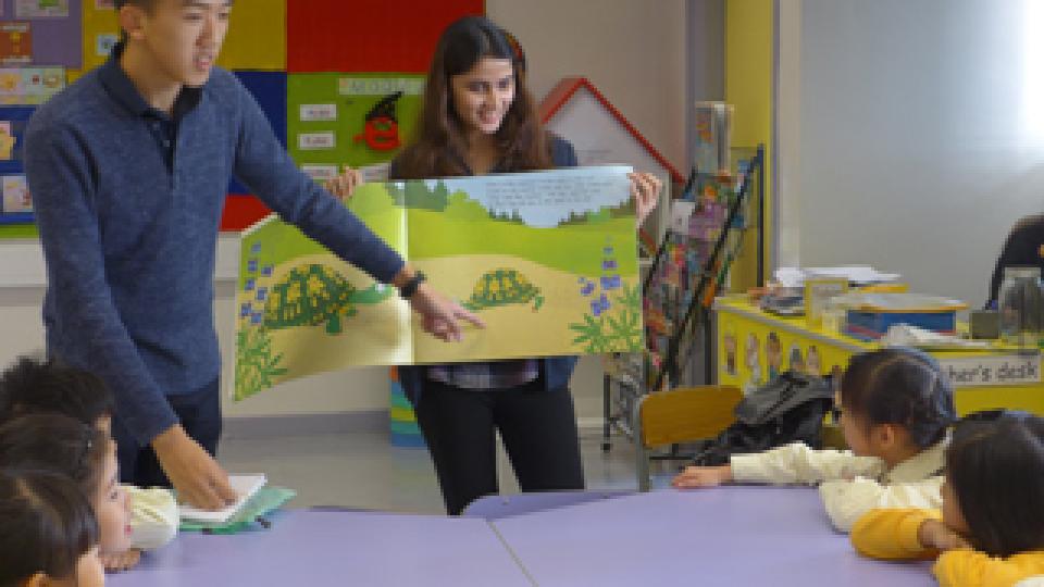 Volunteers serving as reading buddies for children