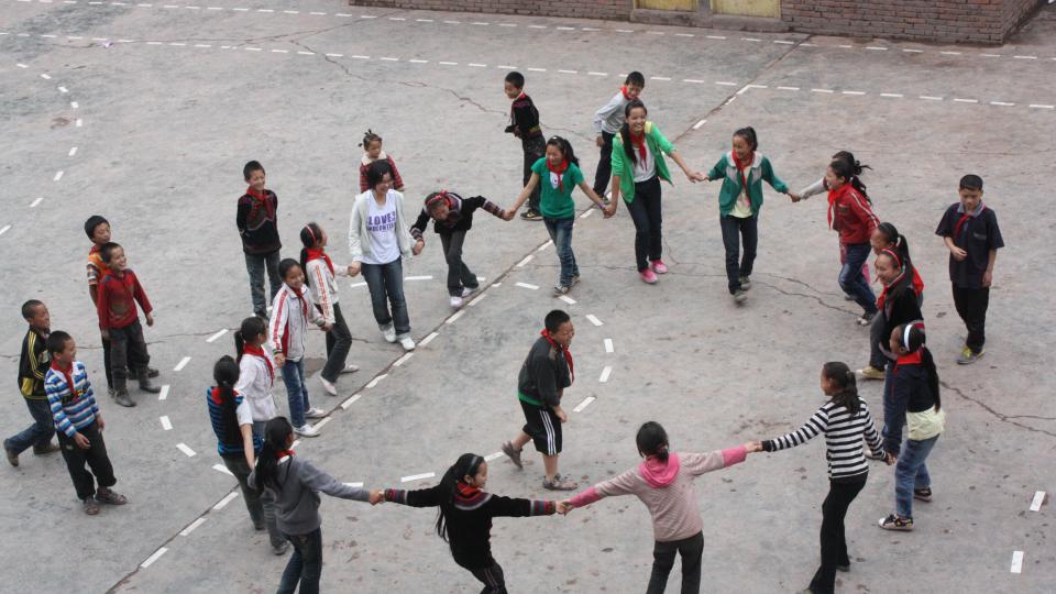 Our students and the local children playing games happily