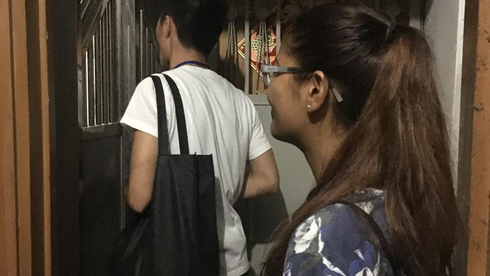 Volunteers approaching a household living in a subdivided housing unit