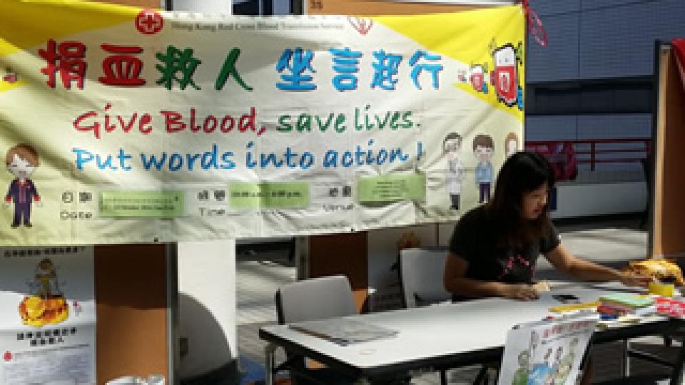 Volunteers setting up the promotion counter at the atrium