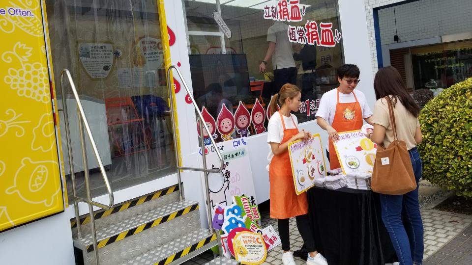 Volunteers hosting booth games to promote blood donation