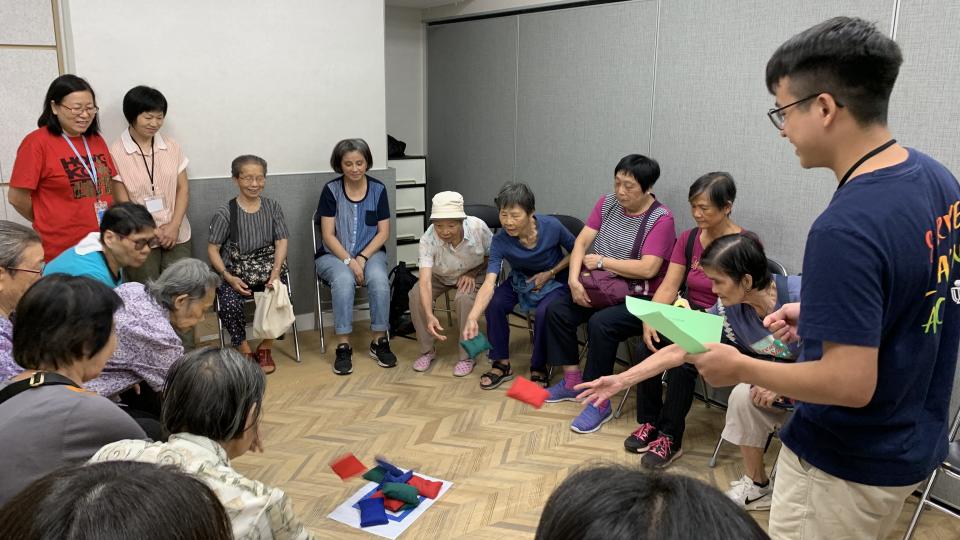 Student volunteers hosted interactive games for the elderly seated in a circle