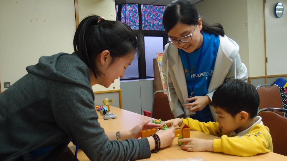 Volunteers are playing games with the child
