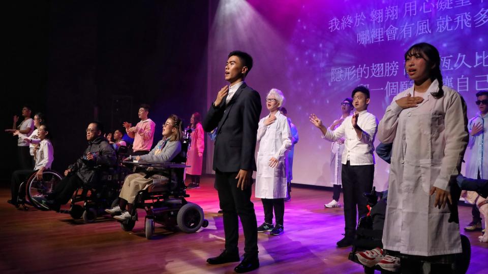 Participants performing musical on stage.