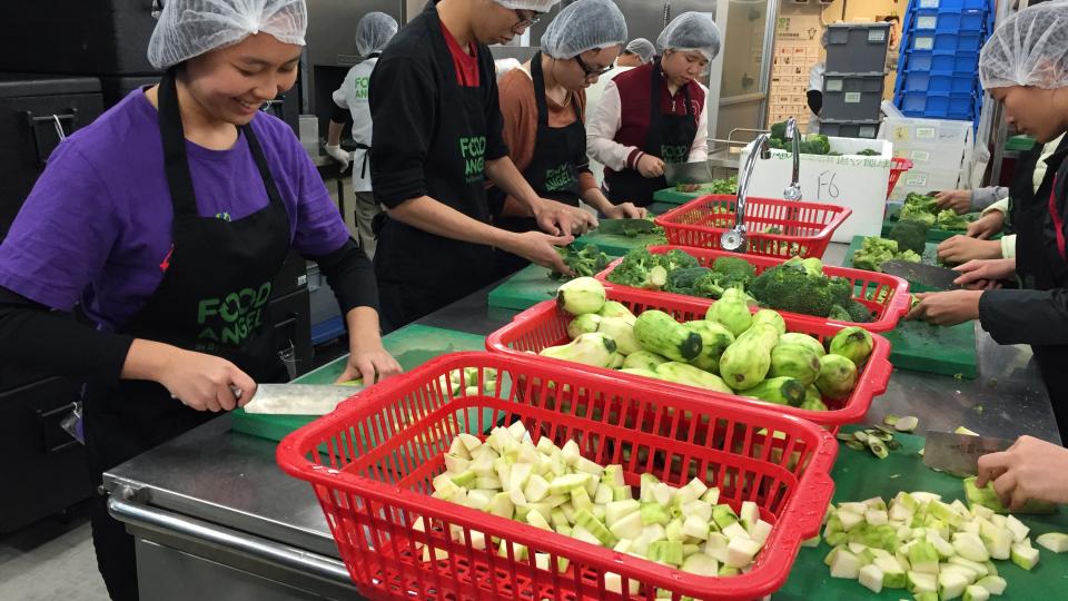 Volunteers preparing ingredients for Food Angel