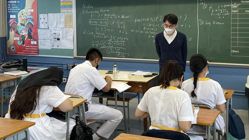Volunteer teaching secondary school students.