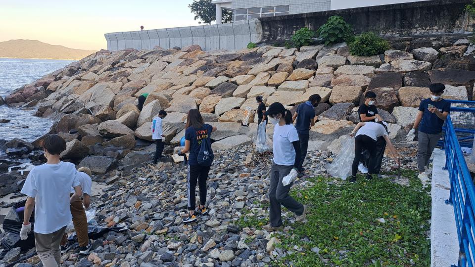 Volunteers picking up trash on the beach.