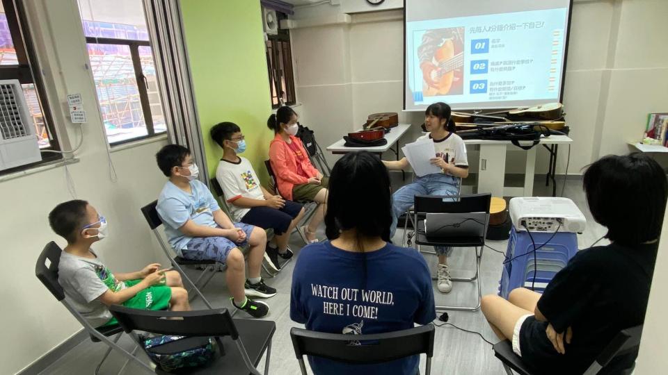 civic fellow holding guitar workshop for children