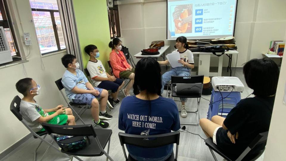 civic fellow holding guitar workshop for children