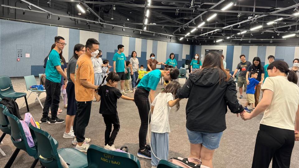 All volunteers and families play checkpoint game together