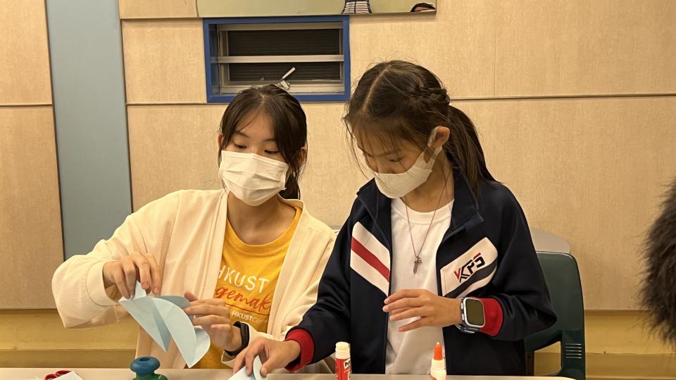 Volunteer making lanterns with the participant