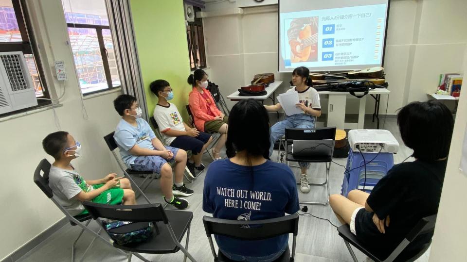 civic fellow holding guitar workshop for children