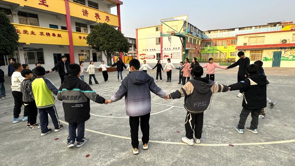 Volunteers playing mass game with Guilin students