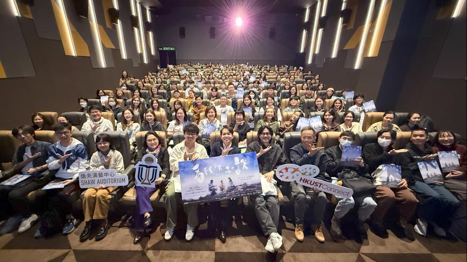 Participants and movie crew members taking a group photo with sign language