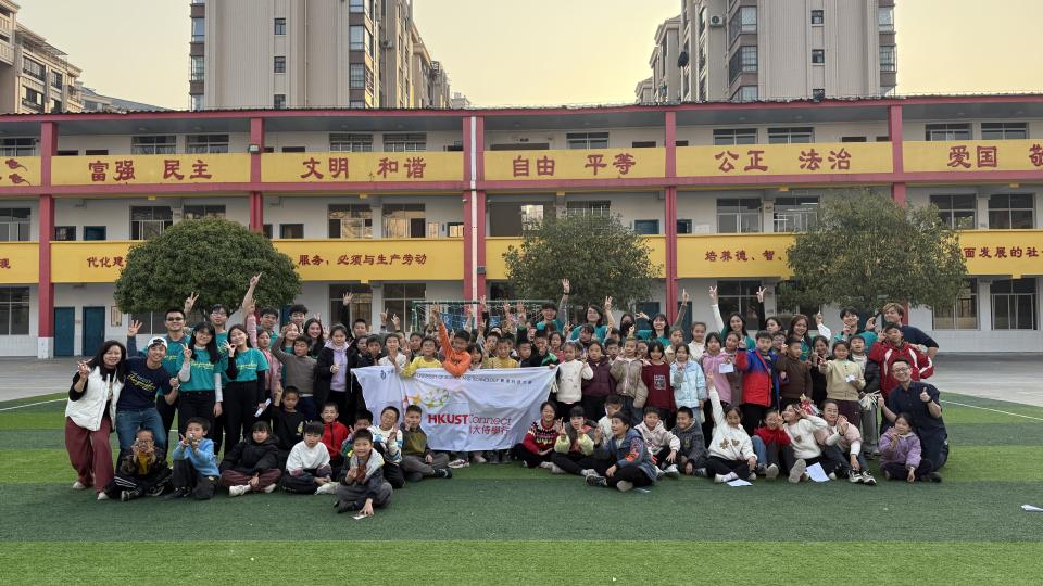 students and volunteers in front of the school building