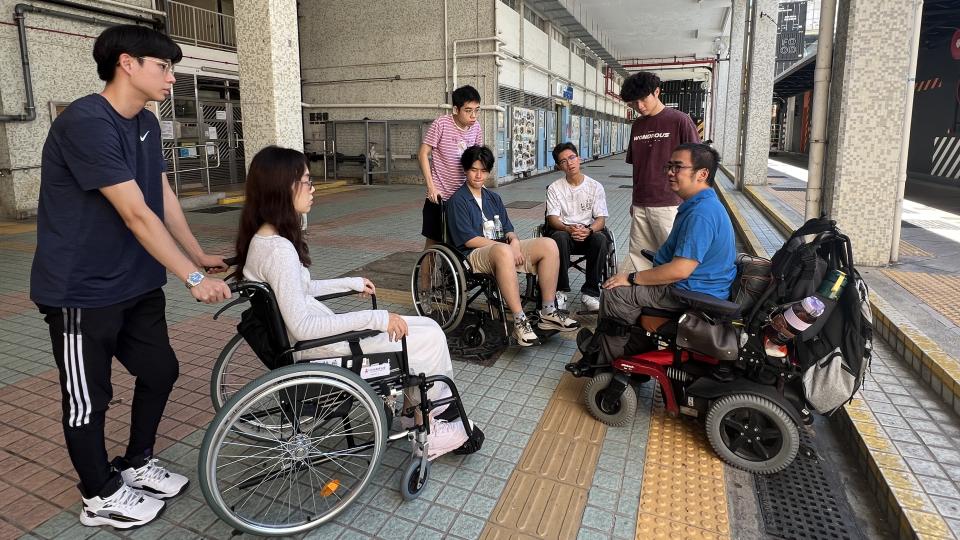 Students exploring the community in wheelchairs