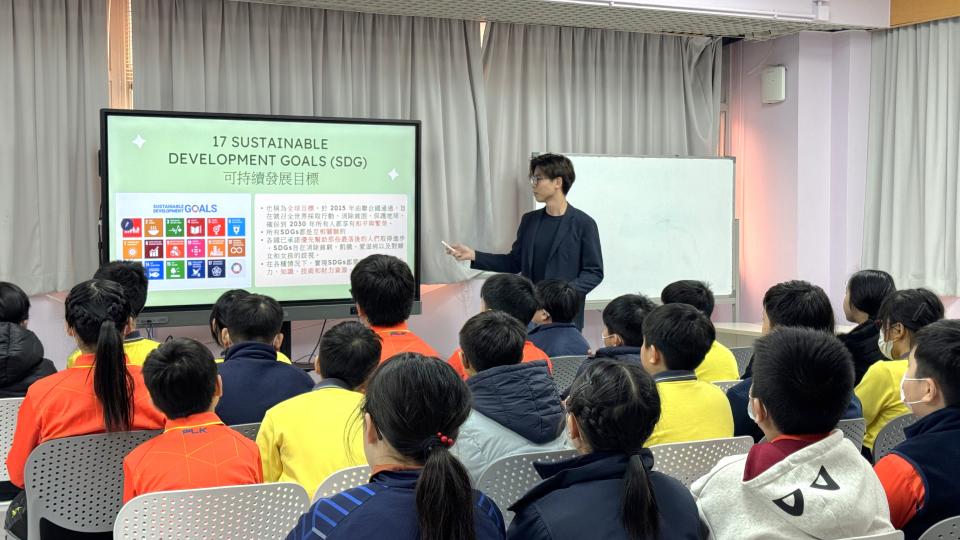 Volunteer teaching students about the Sustainable Development Goals (SDGs)