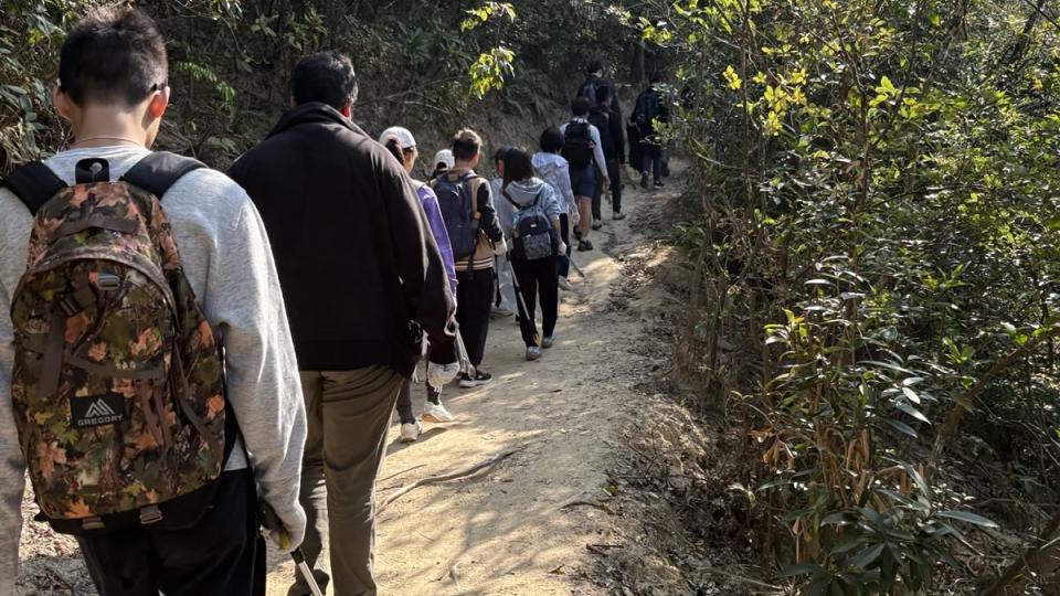 Volunteers scanning the trails for litter